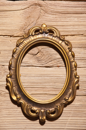 golden frame on wood texture backgroundの写真素材