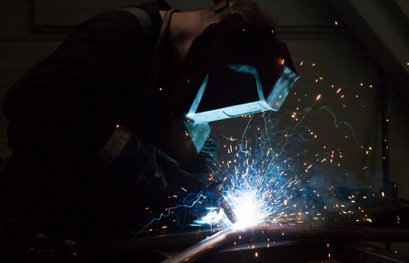 Industrial Worker at the factory welding closeup