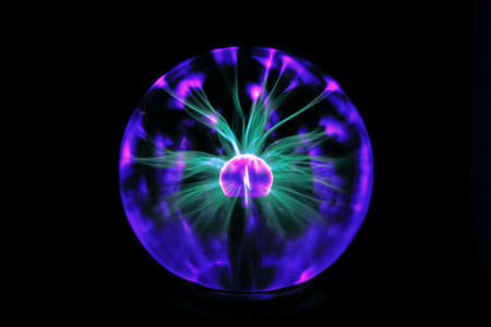 Decorative lamp in the shape of a plasma ball with red and blue tesla electrodesの写真素材