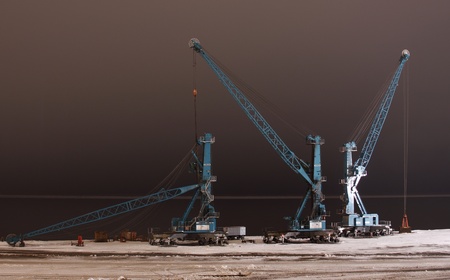 Port cranes in expectation of arrival of a vessel Dudinka, Russian Federationの写真素材
