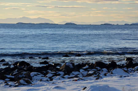 fantastic ocean landscape with mountains and a light mist deep in the seaの写真素材