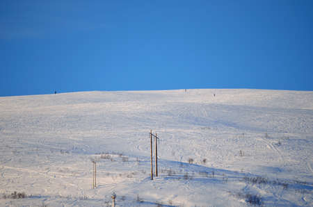 people walking up snowy mountainの写真素材