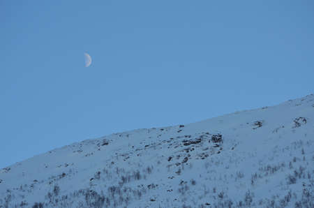 moon over snowy mountain