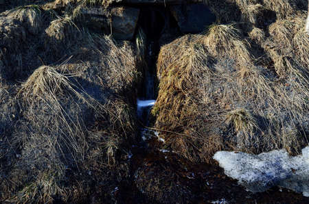 flowing snow melt water drainageの写真素材