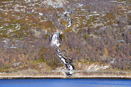big majestic waterfall cutting through the island landscape