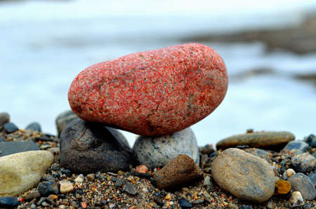 red rock by river shore