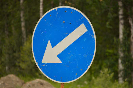 blue direction sign with white arrowの写真素材