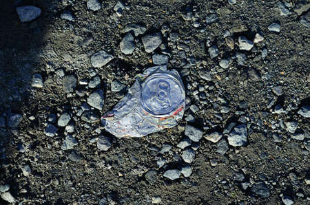 crushed metal can on ground