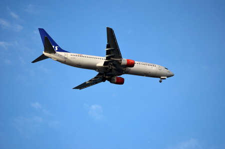 SAS, Scandinavian Airlines plane coming in for landing on a beautiful clear and sunny autumn dayのeditorial素材