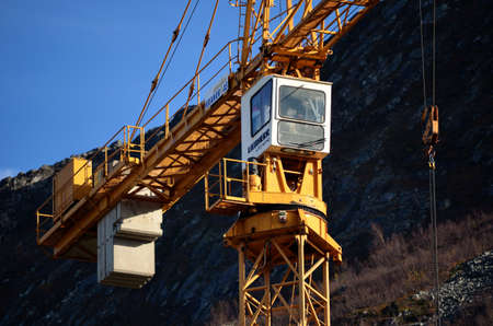 tall yellow construction crane with blue sky backgroundのeditorial素材