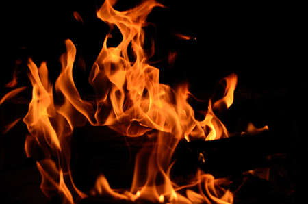Burning birch log in the fireplace on a cold autumn day in Norway