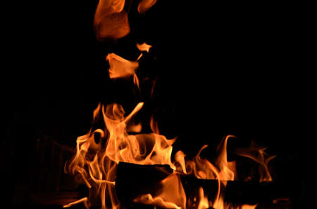 Burning birch log in the fireplace on a cold autumn day in Norway