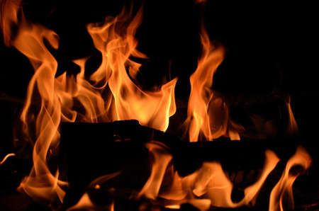 Burning birch log in the fireplace on a cold autumn day in Norwayの写真素材