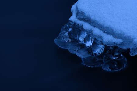 Frozen arctic river water creates beautiful ice shapes in winter macro photo
