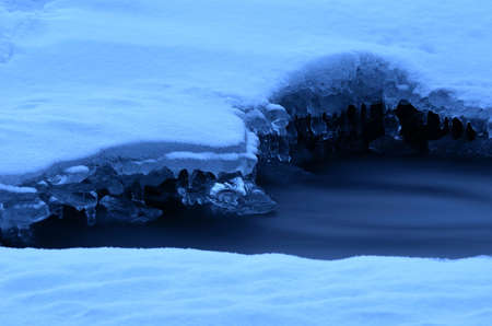 Frozen arctic river water creates beautiful ice shapes in winter macro photo