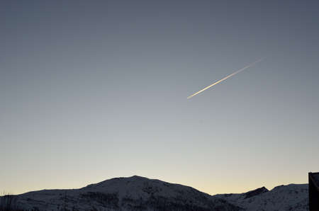 airplane going over the clear winter sky