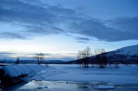 ice, creek and winter mountain landscapeの写真素材
