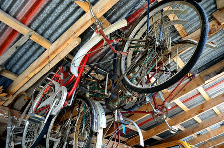 old bicycles hanging from roof raftersの写真素材