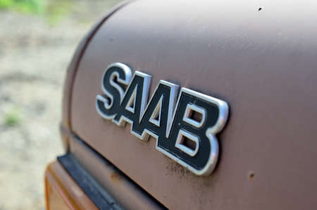 old worn saab badge on car