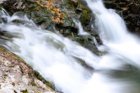 small beautiful fresh water mountainn creek waterfall in summerの写真素材