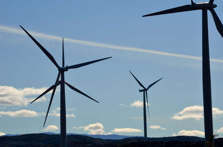windmill farm on mountain top in autumn sun