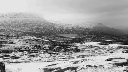 New snow, lake and white mountain landscape in late autumn in the arctic circleの素材