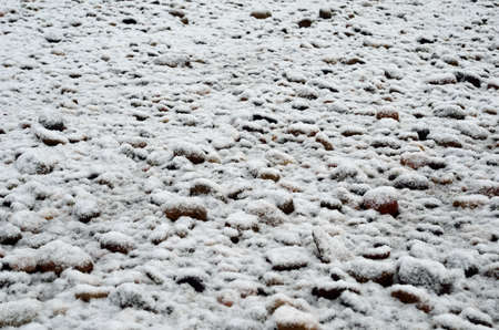 new snow on beach stonesの写真素材