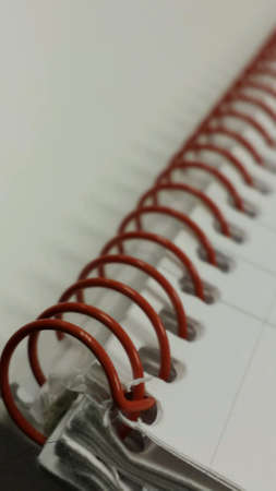 Notepad with red spiral binderの素材