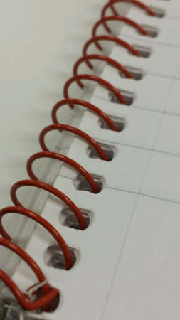 Notepad with red spiral binder
