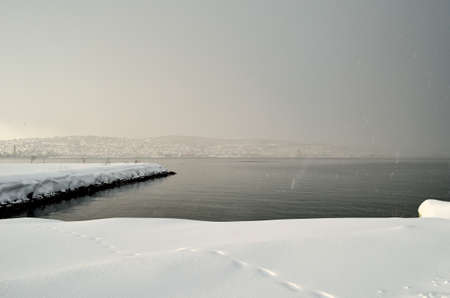 snow and snow heavy clouds over tromsoe city islandの写真素材