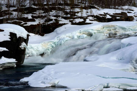 majestic national waterfall in snowy spring melting slowlyの写真素材