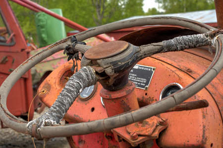 old rusted and weathered tractor steering wheele