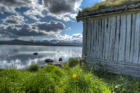 old beautiful weathered boathouse near oceanの写真素材