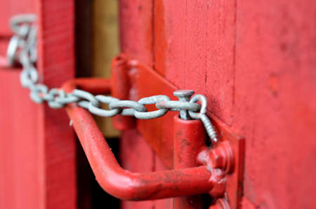 small chain lock on red door