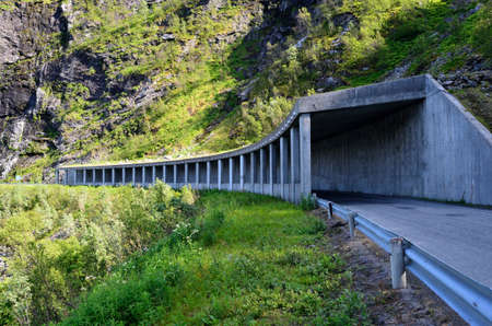semi tunnel in mountain side on senja island for falling rock protectionの写真素材