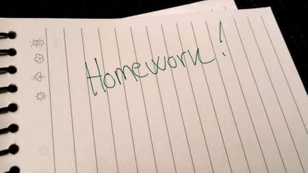 Homework written on white notepadの素材