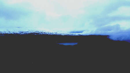 New snow on mt mauken with brown mossy landscape and fresh water mountain lake in autumnの素材