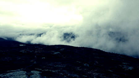 Thick mist shrouding mountains and the maalselv river valley in late autumn dawn overview