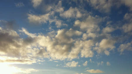 Vibrant blue sky with sunshine and clouds