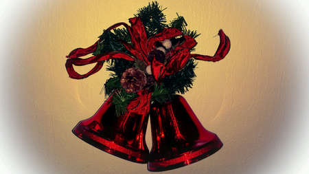 Red christmas bells with bow tie on wallの素材