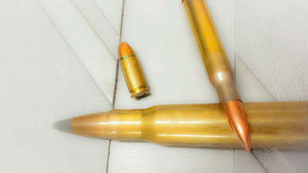 Different sized ammunition flat on plastic case macro photo
