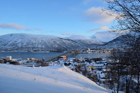 tromso city in wintertime with snow and sunshine overivew photo february 7th 2016のeditorial素材