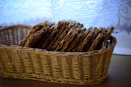 crispbread in wicker basket on kitchen tableの写真素材