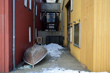 small wooden boat between two buildingsの写真素材