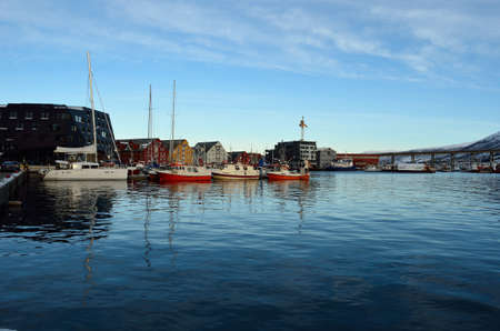different boats docket in tromsoe city harbour on a sunny blue day 20th february 2016のeditorial素材