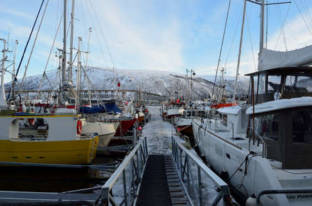 different boats docket in tromsoe city harbour on a sunny blue day 20th february 2016のeditorial素材