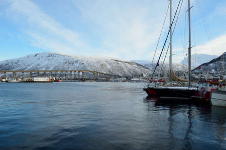 different boats docket in tromsoe city harbour on a sunny blue day 20th february 2016のeditorial素材