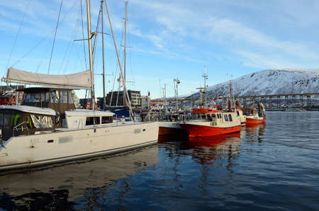 different boats docket in tromsoe city harbour on a sunny blue day 20th february 2016のeditorial素材