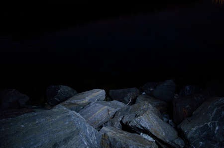 dark rocky sea shoreの写真素材