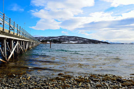beautiful old bridge crossing two islands over ocean in sunshineの写真素材
